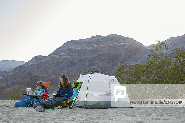 Boy and teenage girl camping in desert  Death Valley National Park  California  USA
