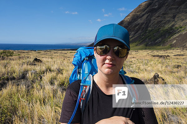 Portrait of female hiker backpacking along the Keauhou Trail from Halape to Chain of Craters Road in Hawaii Volcanoes National Park on the Big Island  Hawaii  USA