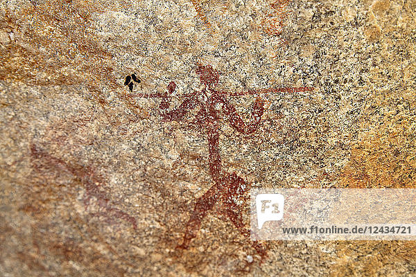 Ancient rock art of painting depicting a human carrying a spear at Matobo National Park Zimbabwe Africa