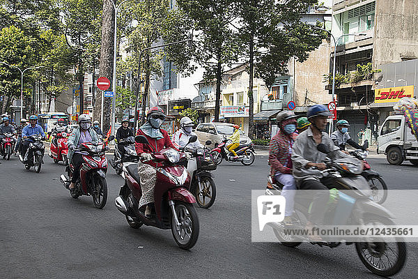 Motorcyclists on a busy street in Ho Chi MInh City  Vietnam  Indochina  Southeast Asia  Asia