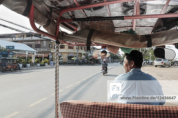 Tuk tuk driver in the streets of Kampt Town  Cambodia  Indochina  Southeast Asia  Asia