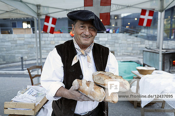 Baker with artisan bread  the agriculture fair (Comice Agricole) of Saint-Gervais-les-Bains  Haute Savoie  France  Europe