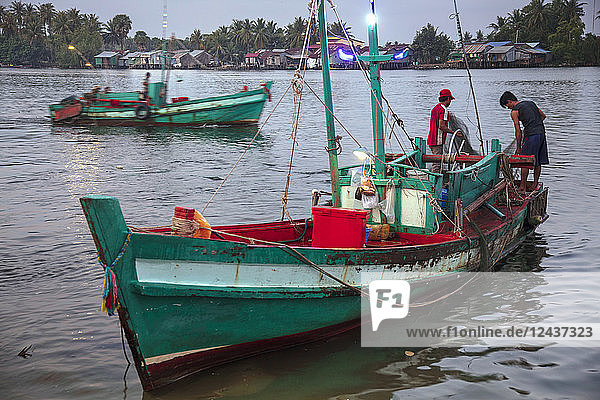 Fishing boat at the morning fish market on the banks of the Preaek Tuek Chhu River in Kampot town  Cambodia  Indochina  Southeast Asia  Asia