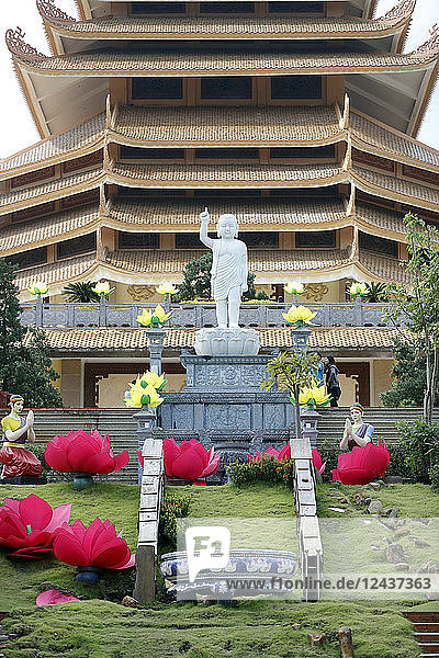 Boy Buddha statue at the top of the stairs with long-ears and one finger pointing to the sky  Minh Dang Quang Buddhist Temple  Ho Chi Minh City  Vietnam  Indochina  Southeast Asia  Asia