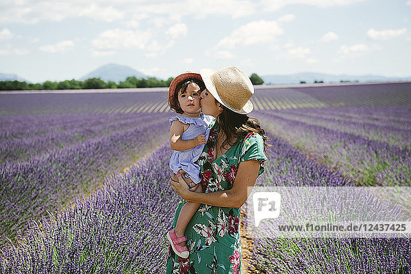 France Provence Valensole plateau Mother kissing daughter in lavender fields in the summer