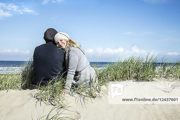 Couple sitting in dunes