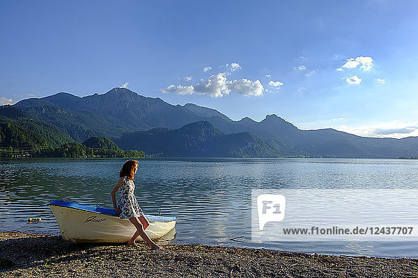 Germany  Bavaria  Upper Bavaria  Heimgarten  teenage girl leaning on boat at Kochelsee