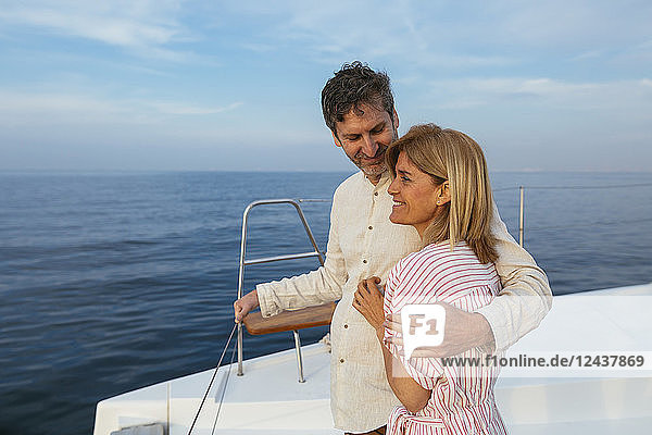 Mature couple enjoying quality time on sailing trip on a catamaran