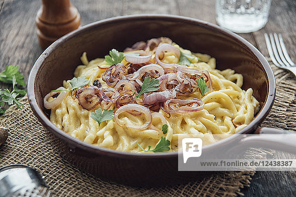 Traditional swabian cheese spaetzle  egg noodles with cheese  cream  roasted onions