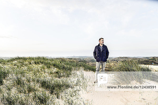 Man standing in dune landscape