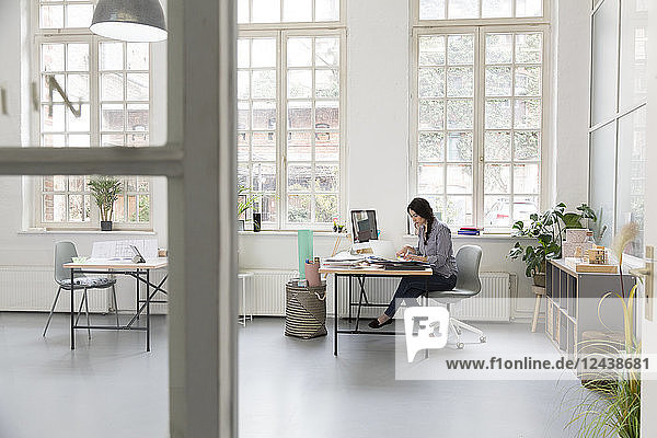 Woman working at desk in a loft office