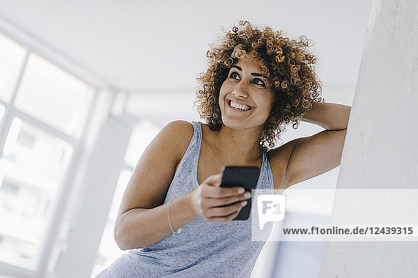 Laughing woman using smartphone