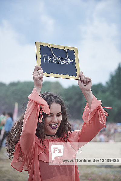 Woman holding sign at music festival  freedom