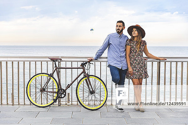 Spain  Barcelona  couple with bicycle standing at the seaside