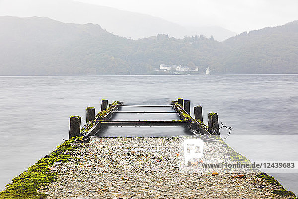 UK Scotland wreck of a pier going into a lake in the highlands