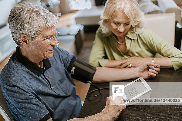 Senior couple taking blood pressure