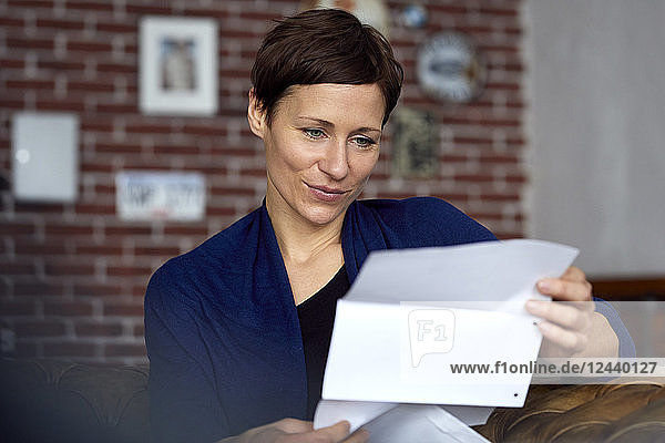 Woman reading letter at home