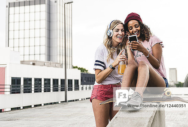 Best friends with skateboard  having fun together  listening music