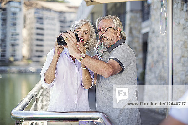 Senior couple taking a city break  taking photos