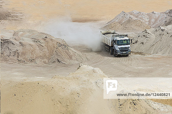 Truck driving through sand heaps