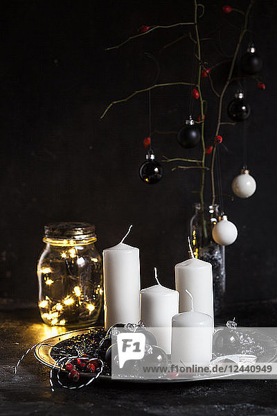 Advent decoration with white candles and black baubles