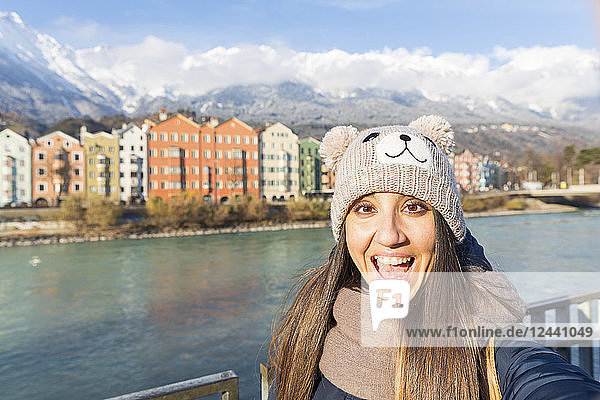 Austria  Innsbruck  portrait of excited woman taking selfie