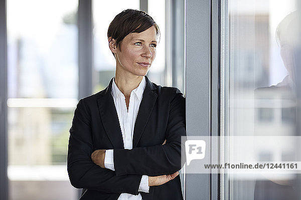 Businesswoman in office looking out of window
