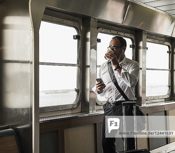 Businessman on a ferry looking out of window