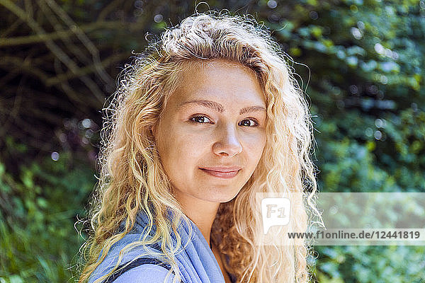 Portrait of smiling blond woman in nature