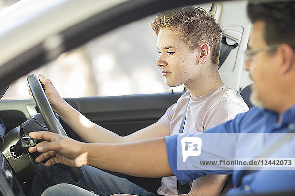 Learner driver with instructor in car