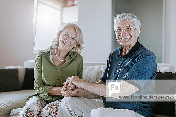 Portrait of smiling senior couple at home