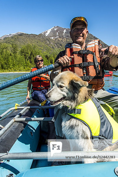 Couple with dog in a raft on the Kenai River near Skilak Lake  South-central Alaska; Alaska  United States of America