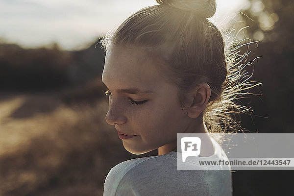 Nahaufnahme eines Mädchens im Teenageralter im Gegenlicht des Sonnenlichts; Los Angeles  Kalifornien  Vereinigte Staaten von Amerika