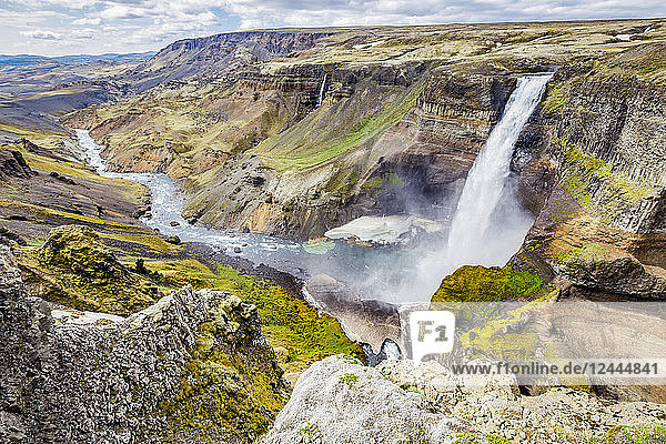 A high viewpoint of one of the waterfalls and rivers in the Haifoss valley with stunning cliffs natural colors and rock formations Iceland