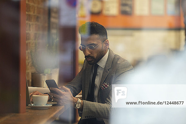 Businessman using smart phone  working in cafe