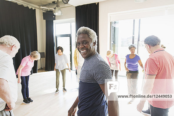 Portrait smiling  confident senior man exercising in circle