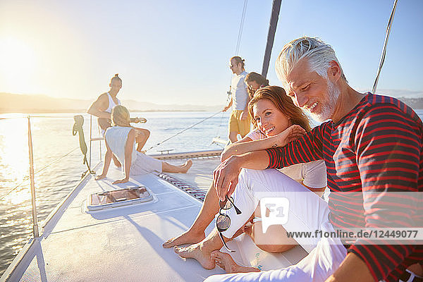 Friends relaxing on sunny catamaran
