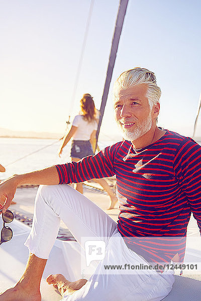 Portrait confident man relaxing on sunny boat