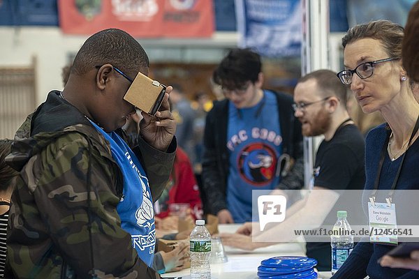 Visitors use Google virtual reality goggles at the Google booth at a Career Expo held at the FIRST Robotics NYC Championship at the Fort Washington Armory in New York on Sunday  April 8  2018. The expo enables participants to speak with companies and professional organizations giving a real-world look into science and technology as used in the business world and their career opportunities.