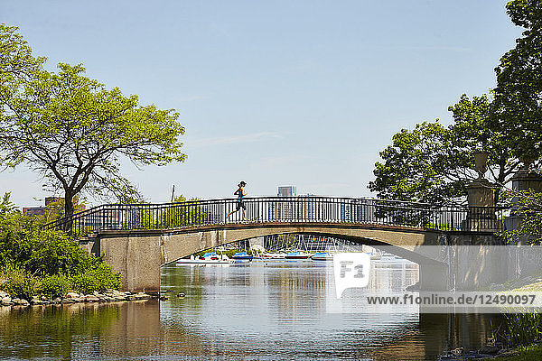 Woman Running On Bridge Along The Charles River In Boston