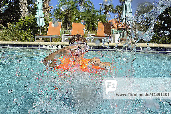 Kid With Swimming Goggle Playing In Swimming Pool
