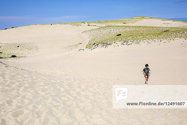 A Boy Walking On Sand Dune In Provincetown  Massachusetts