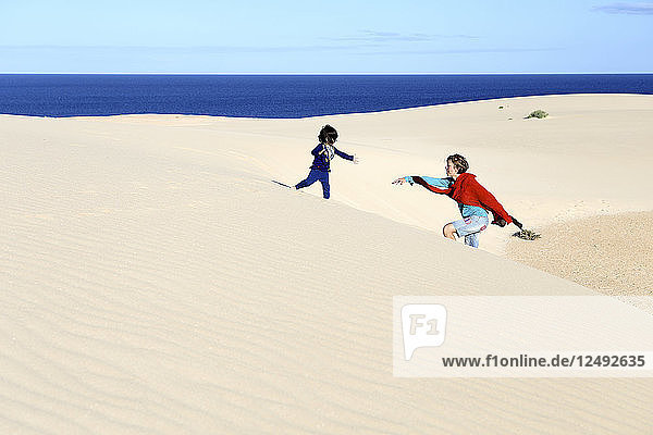 Mutter  die mit ihrer Tochter in den Sanddünen von Corralejo  Spanien  spielt