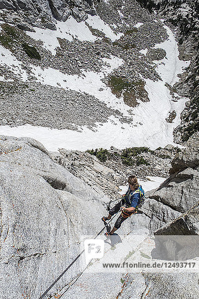 A Man Rappels Off A Climb Back Down To The Lone Peak Cirque In The Wasatch Mountains