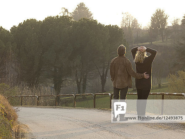 Mature couple pause on country road