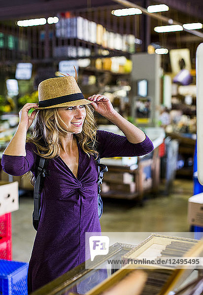 A young woman tries on a traditional hat during a vacation in Puerto Rico.