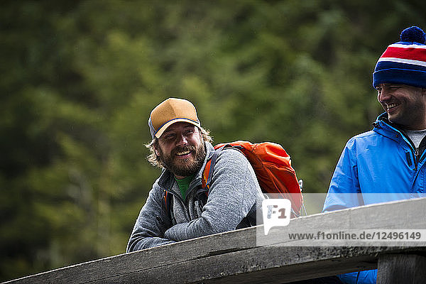 A couple of friends laugh together after fishing in Squamish  British Columbia.