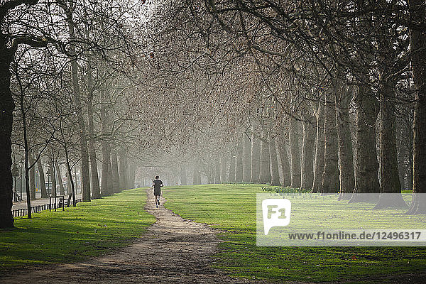 Man trail running in Hyde Park  London