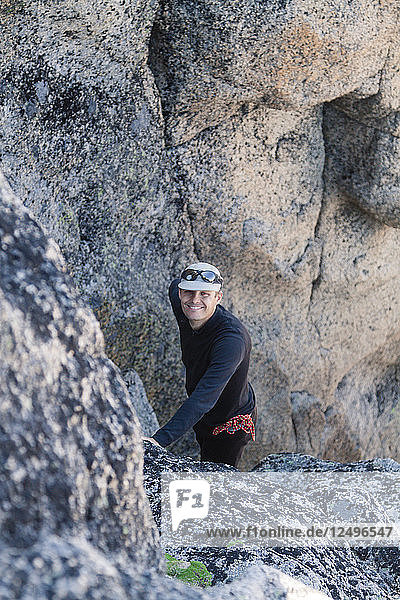 Portrait of a climber taken during a scramble up Grimface Mountain in Cathedral Lakes Provincial Park  British Columbia  Canada.