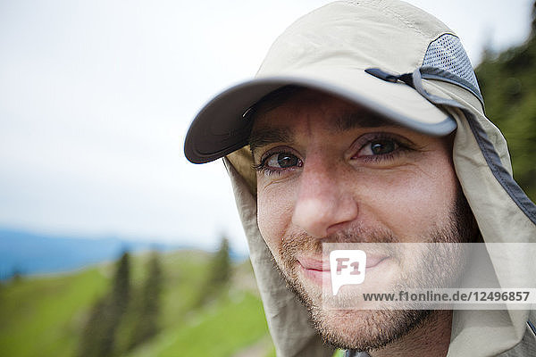 Portrait of a hiker wearing a bug net hat to protect from insect bites.